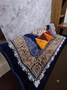 a table with three pillows on top at Hidden Villa in Al Ain