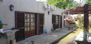 a house with wooden doors and a patio at S de uribe in Uribelarrea