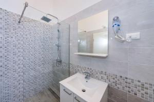 a white bathroom with a sink and a shower at Apartment Paulo&Lorenco in Sveti Filip i Jakov +58 photos