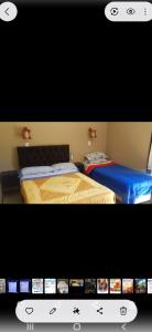 two beds in a room with a computer screen at S de uribe in Uribelarrea