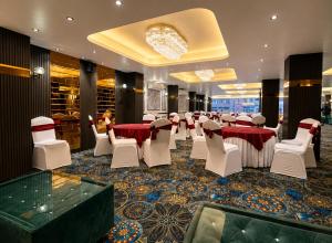 a banquet hall with red and white tables and chairs at Hotel Prince Paradise in Patna