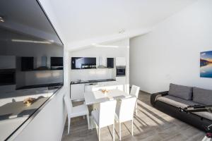a living room with a table and a couch at Apartment Paulo&Lorenco in Sveti Filip i Jakov