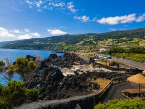 a view of the ocean and a train station at Adega do Carlos Pinheiro in São Roque do Pico