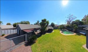 an aerial view of a house with a large yard at Stylish 1-Bed Cottage,Garden, Pool Secure Parking in Alberton