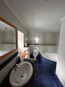 a bathroom with a sink and a tub and a toilet at A Casa dos Meus Sonhos in Santo Amaro +20 photos