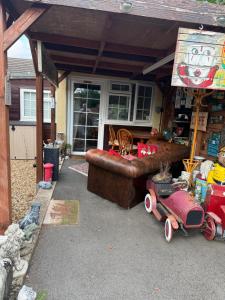 an outdoor patio with a couch and a table at Private en-suite RUTHIN in Llanfair-Dyffryn-Clwyd