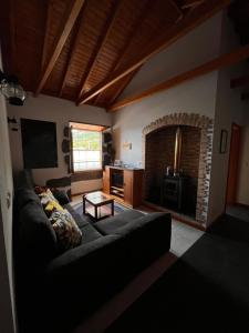 a living room with a couch and a fireplace at A Casa dos Meus Sonhos in Santo Amaro
