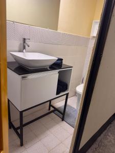 a bathroom with a sink and a toilet at The Cozy House in Estelí