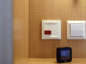 a cell phone sitting on a table next to a lightswitch at ibis Konstanz in Konstanz +47 photos