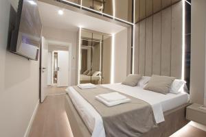 a bedroom with a large bed with two towels on it at Bacovia Grand Apartment- Free Parking in Bacău