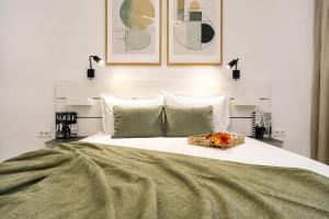 a bedroom with a large bed with a tray of flowers on it at Sasha Wave Studio in Popeşti-Leordeni