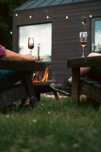 two people sitting at a picnic table with two glasses of wine at TogetherNest - Ash in Mătişeşti +41 photos