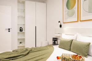 a bedroom with a bed with a tray of food on it at Sasha Wave Studio in Popeşti-Leordeni