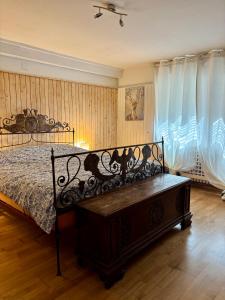 a bedroom with a bed and a bench in it at Ca' Scalinatella in Cortina dʼAmpezzo