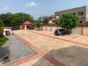 a car parked in a parking lot next to a building at Tranquility Lodge in Abrekuma