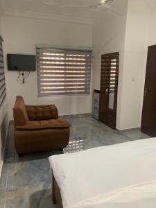 a living room with a bed and a couch at Tranquility Lodge in Abrekuma +6 photos