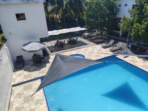 an overhead view of a swimming pool with an umbrella at Naru CasaBlanca in Utica