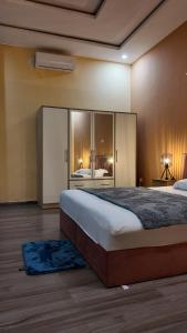 a bedroom with a large bed with a large window at Belle Villa Kassonyah, Conakry in Conakry +41 photos