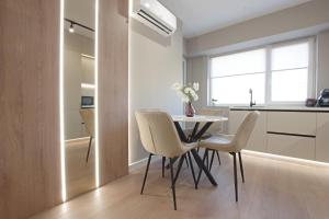 a kitchen and dining room with a table and chairs at Bacovia Grand Apartment- Free Parking in Bacău +20 photos