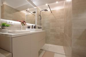 a bathroom with a sink and a shower at Bacovia Grand Apartment- Free Parking in Bacău