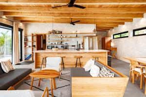 a kitchen and living room with wooden ceilings at Seabird Villa 3 in Placencia
