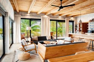 a living room with a couch and a table at Seabird Villa 3 in Placencia