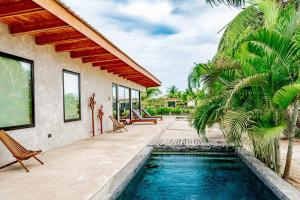 a swimming pool in the backyard of a house at Seabird Villa 3 in Placencia