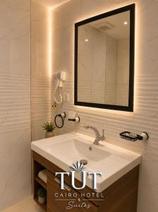 a bathroom with a sink and a mirror at TUT Cairo Hotel & Suites in Cairo