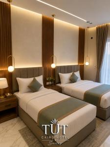 two beds in a hotel room with two beds sidx sidx sidx at TUT Cairo Hotel & Suites in Cairo +6 photos