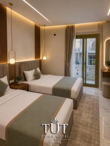 a hotel room with two beds and a balcony at TUT Cairo Hotel & Suites in Cairo