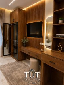 a hotel room with a tv and a bedroom at TUT Cairo Hotel & Suites in Cairo