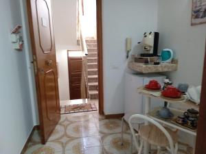 a small kitchen with a table and chairs in a room at Casa Monteserrato in Terrasini