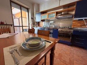 a kitchen with a table with a bowl of soup on it at Santa Marta Apartment in Biella