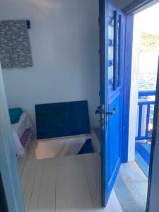 a bathroom with a tub and an open door at Palirroia (High Tide) in Empourios