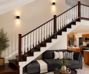 a living room with a couch and a staircase at Apartment in St Ann in Priory
