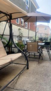 a group of tables and chairs with an umbrella at Tropical Oasis in Rosedale
