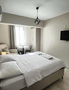 a bedroom with a white bed and a living room at Rain Suite in Istanbul +5 photos