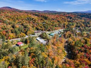 an aerial view of a farm in the autumn forest at Griffin Chalet 5 in Stowe
