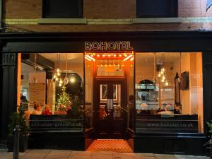 a store front of a restaurant at night at BOHOTEL in Macclesfield