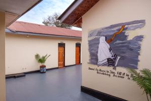 a large painting on the side of a building at Elikai Hostels  +9 photos