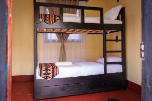 a bunk bed room with a bunk bed with a bunk bed at Elikai Hostels 