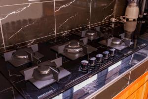 a stove top with a bunch of knobs on it at Elikai Hostels 