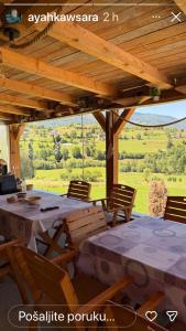 a table and chairs under a wooden pergola at CAMP Odmaraliste PURISIC in Plav