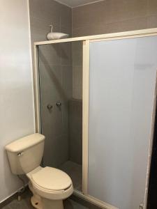 a bathroom with a toilet and a shower at Beautiful, comfortable and functional apartment 4 in Guadalupe