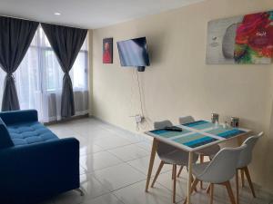 a living room with a table and a blue couch at Beautiful, comfortable and functional apartment 4 in Guadalupe