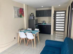 a kitchen and dining room with a table and chairs at Beautiful, comfortable and functional apartment 4 in Guadalupe