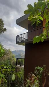 a building with a balcony on top of a hill at Loft Montclair in Nova Lima