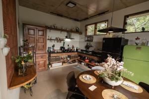 a kitchen with a table and a green refrigerator at Loft Montclair in Nova Lima