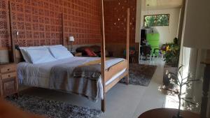 a bedroom with a bed with a wooden frame at Loft Montclair in Nova Lima