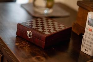 a wooden box sitting on a table with a chessboard at Loft Montclair in Nova Lima